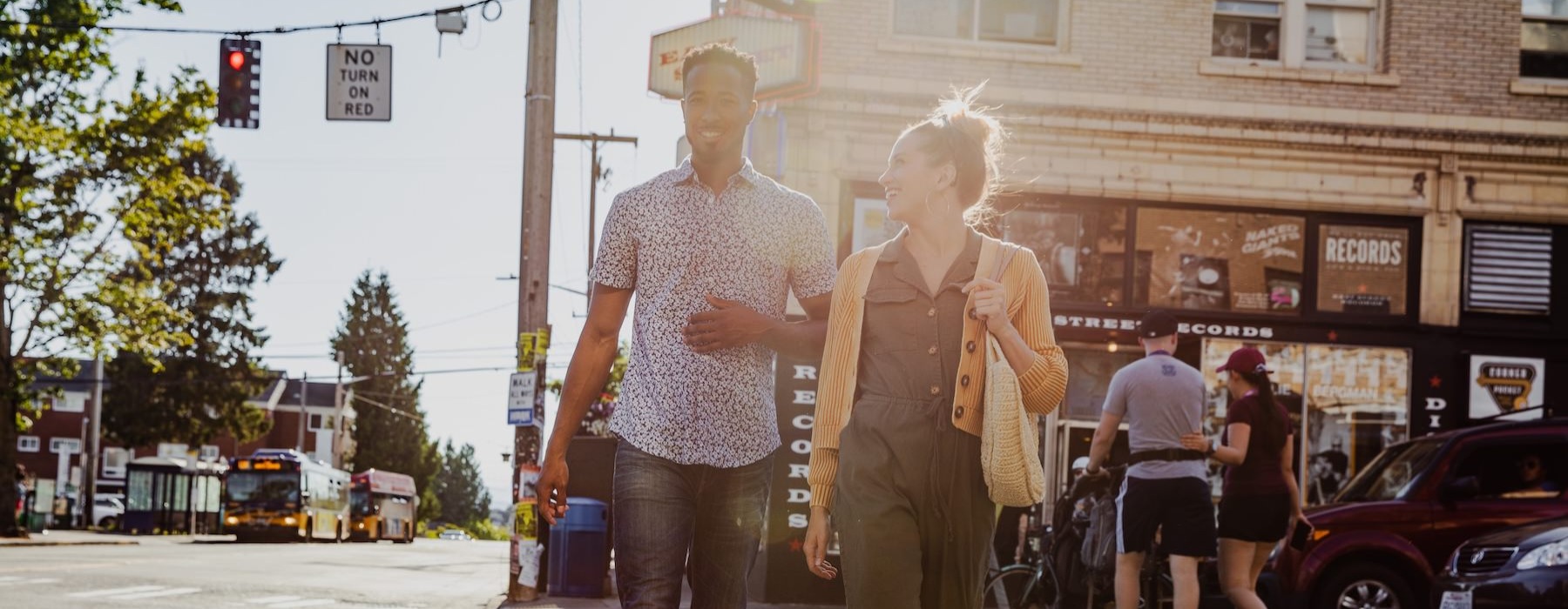 a man and woman walking on a crosswalk