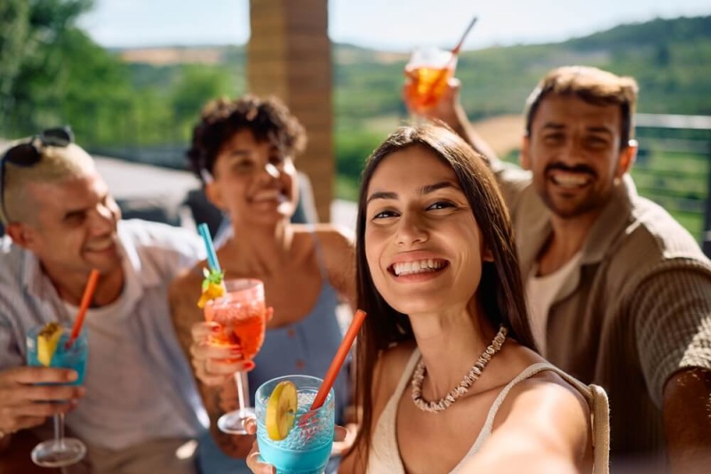 a group of people holding drinks