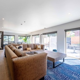 a lounge with a couch and a coffee table