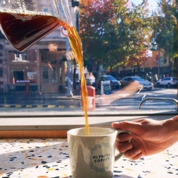 a cup of coffee being poured