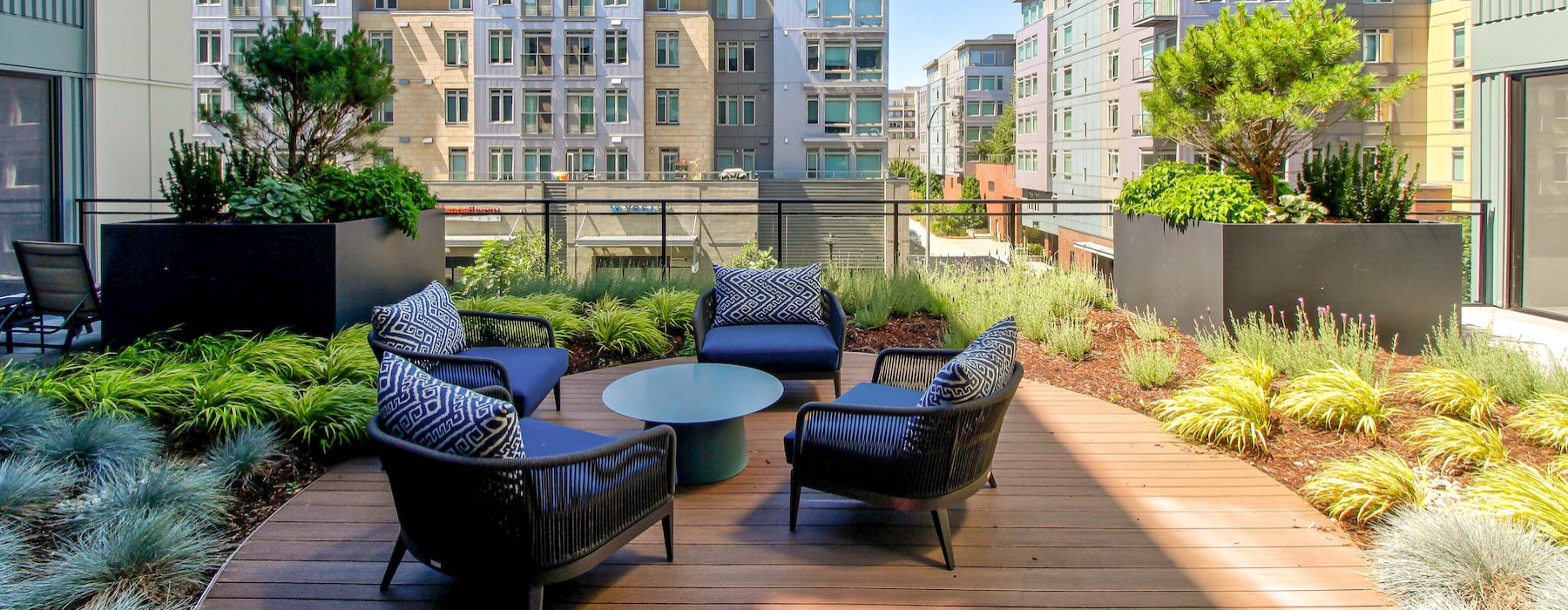 a rooftop lounge with a table and chairs
