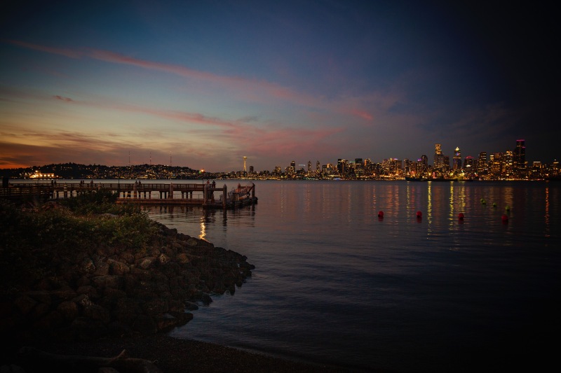 a body of water with a city in the background