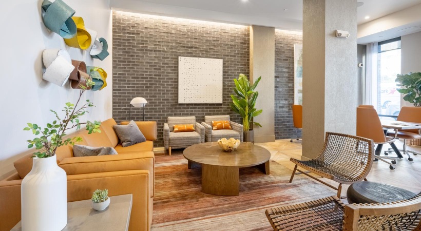 a lounge with a couch, tables and chairs