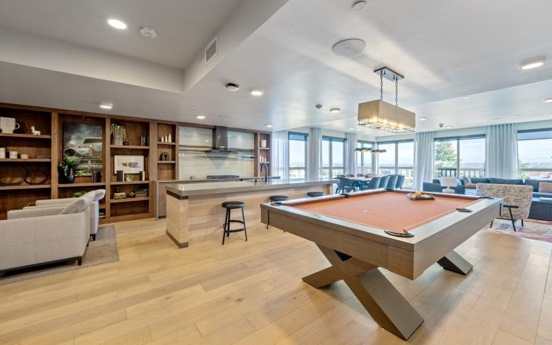 a clubroom with a pool table and a couch