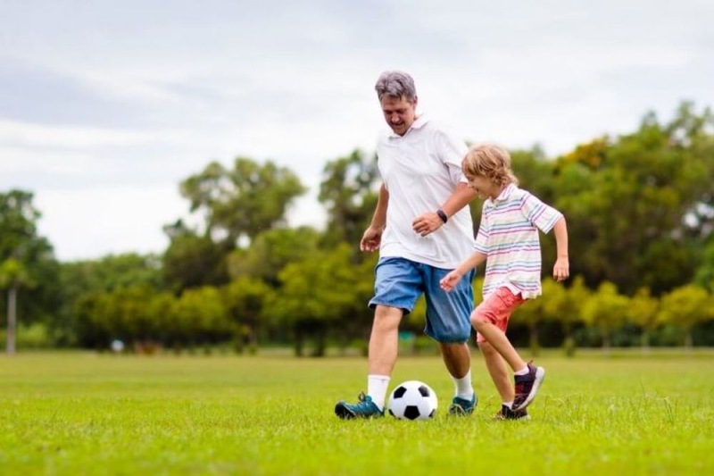 a man and a child playing football