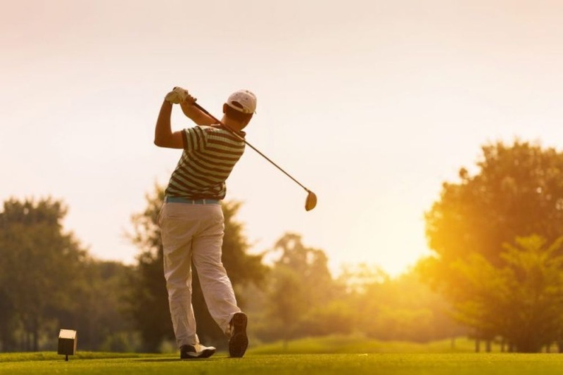a man swinging a golf club