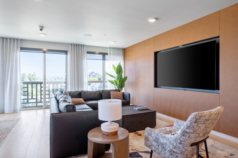 a spacious room with a tv and couches