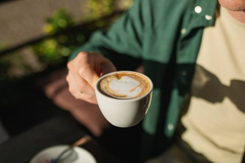 a person holding a cup of coffee