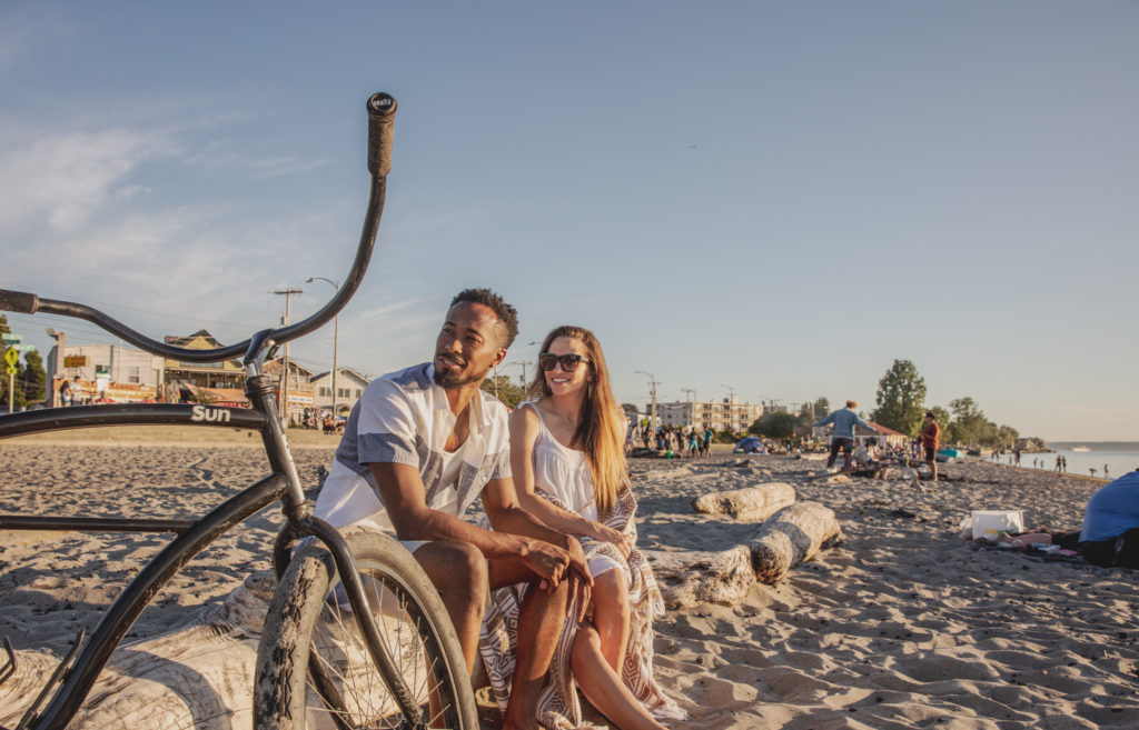 Maris Seattle couple sitting on a beach