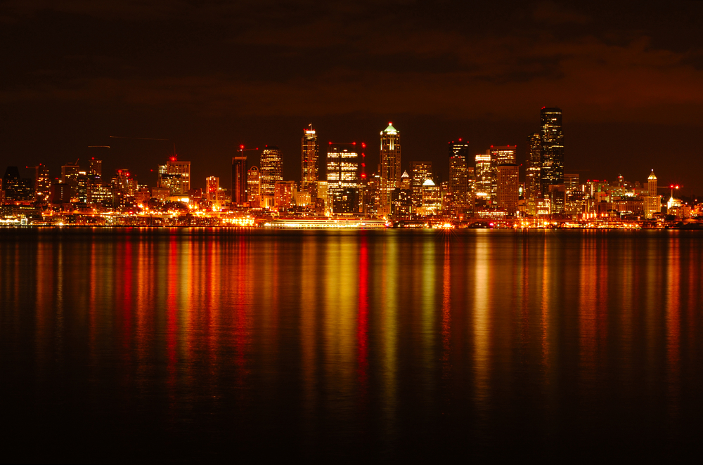Seattle city downtown skyline dazzled and reflected in the waters of Puget Sound