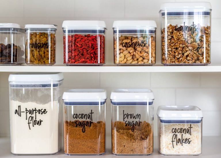 neatly organized jars inside a pantry with tags
