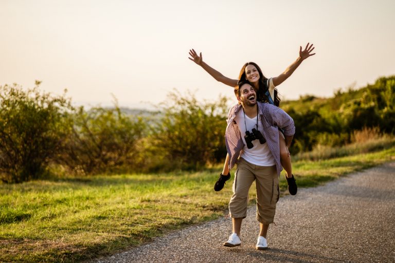 happy couple hiking in mountain