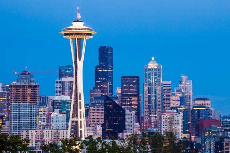 Seattle skyline with the Space Needle and city buildings at dusk.